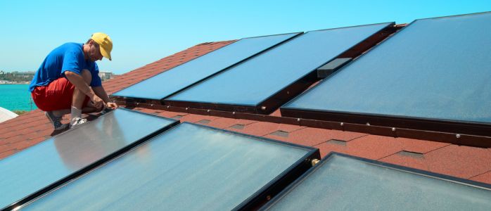 An image showcasing the installation of solar roof tiles on a rooftop for efficient energy production and consumption