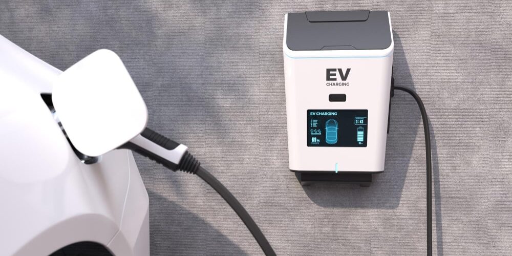 A man inspecting multiple EV chargers installed in a home