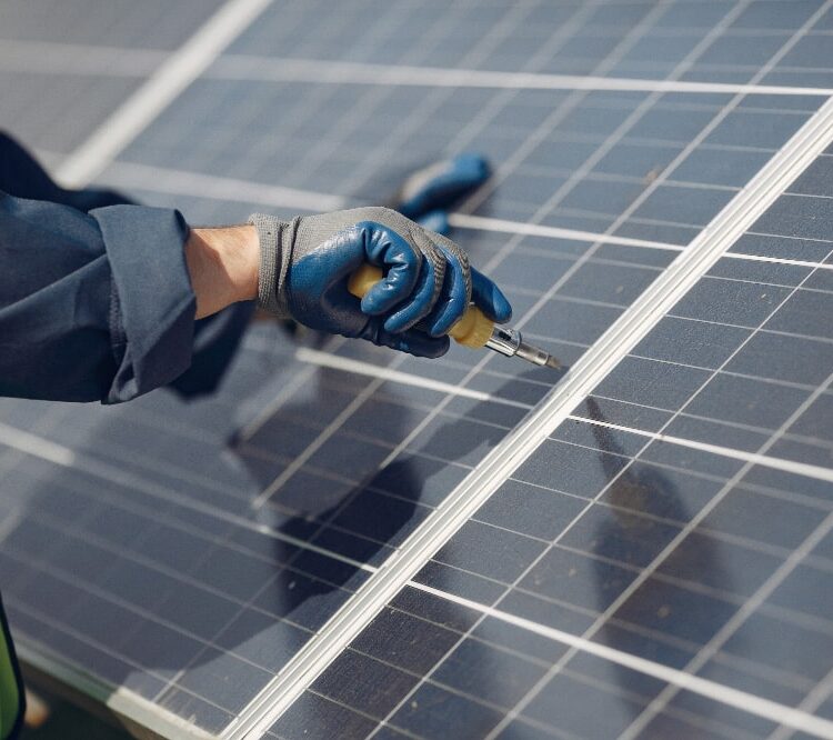 a picture showing a man mounting solar panels